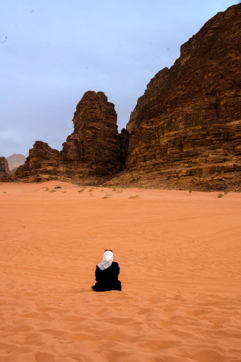 Lady sitting on the sand dune